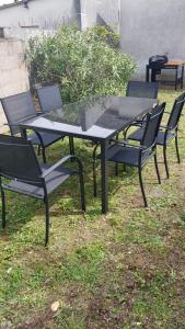 a group of tables and chairs sitting on the grass at Maison avec jardin in Issoudun