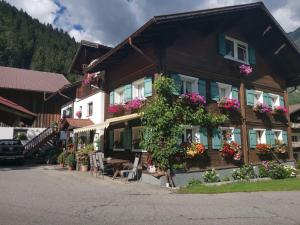 a house with flowers on the side of it at Comfortable house with garden in Voralberg in Sankt Gallenkirch