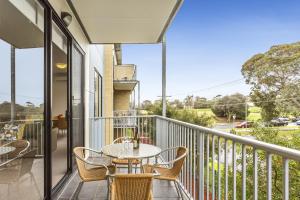 a patio with a table and chairs on a balcony at Quest Frankston in Frankston