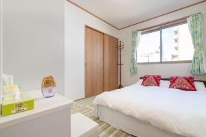 een slaapkamer met een bed en een raam bij Travel Palace Miyuki in Kawaguchi