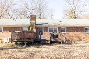 a brick house with a fence in front of it at Beautiful Home. W/Hot Tub. Great Location in Taylors