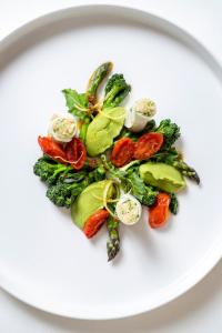 a plate of vegetables on a white plate at Landhaus Tanner in Waging am See