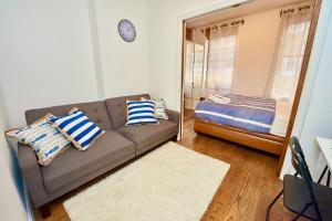 a living room with a couch and a bed at 2 Bedroom Cozy Unit in Lower Manhattan in New York