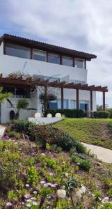 una gran casa blanca con un jardín delante de ella en Hotel Green en Marbella, en Maitencillo