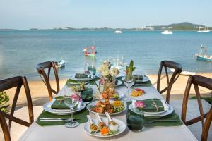 un tavolo con piatti di cibo sulla spiaggia di Baan Leelawadee a Bophut