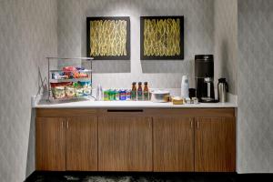 a counter in a kitchen with a refrigerator and drinks at Courtyard by Marriott Nashville Downtown in Nashville