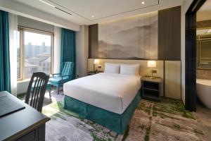 Säng eller sängar i ett rum på Imperial Palace Seoul Gangnam