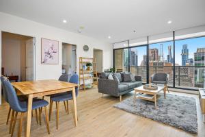 a living room with a table and a couch at Luxe Lonsdale - Your City Retreat in Melbourne in Melbourne