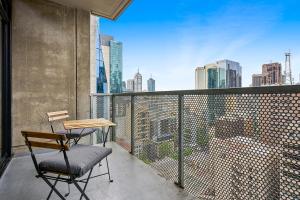 a balcony with a table and chair on a building at Luxe Lonsdale - Your City Retreat in Melbourne in Melbourne