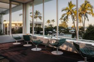 a restaurant with chairs and a table with a view of the ocean at Sheraton Grand Mirage Resort Gold Coast in Gold Coast
