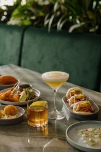 a table topped with plates of food and a drink at Sheraton Grand Mirage Resort Gold Coast in Gold Coast