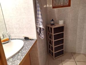 a bathroom with a sink and a mirror and a sink at L'ase et la tuca in Bessan +17 photos