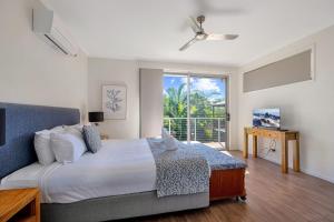 a bedroom with a large bed and a window at Contemporary Home in the Heart of Mudjimba in Mudjimba
