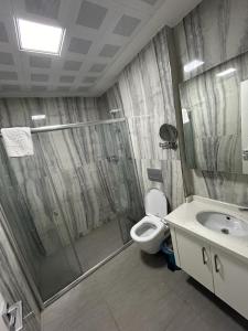 a bathroom with a shower and a toilet and a sink at Graf Victor Hotel in Alanya