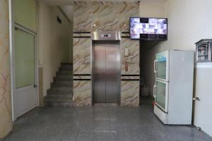 a elevator in a building with a television on the wall at Hotel Trâm Anh 2 in Nhơn Trạch