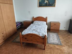 a bedroom with a wooden bed in a room at Tristan@home in Linz