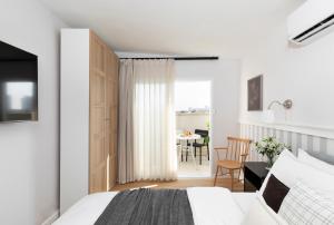 a bedroom with a bed and a dining room at AirTLV - Arlozorov Apartment's in Tel Aviv
