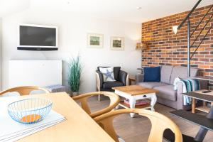 a living room with a couch and a table at Fofftein in Juist