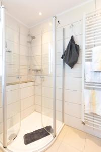 a shower with a glass door in a bathroom at Fofftein in Juist +8 photos