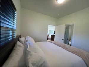 a bedroom with a large bed with white pillows at Vynmir BeachPark Villa in Fort Bragg