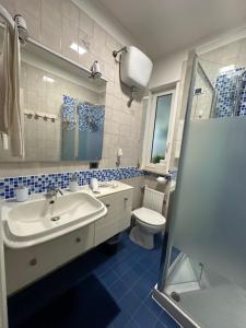 a bathroom with a sink and a toilet at THE HOUSE OF SUNSETS in Rome