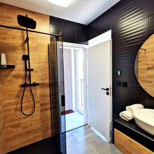 a bathroom with a shower and a sink at MotoChillout in Polańczyk