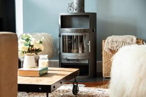 a living room with a tv and a coffee table at Roseberry Cottage - Lower Mill Estate in Somerford Keynes