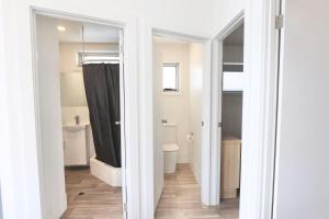 a bathroom with a tub and a toilet and a shower at Sea Vu Caravan Park in Robe