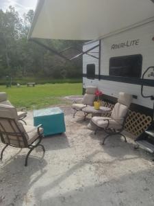four chairs and a table in front of an rv at Clam haven in Crystal River