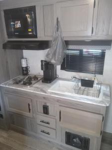 a kitchen with a sink and a microwave at Clam haven in Crystal River