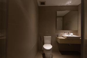 een badkamer met een wit toilet en een wastafel bij Diamond Island Highfloor RiverView 8min to D1 in Ho Chi Minh-stad