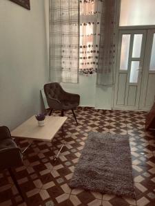 a living room with a chair and a table at Studio apartament in Arad
