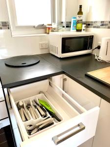 an open drawer in a kitchen with utensils at Location Location Vacation in Fremantle