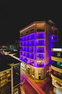 a building with purple lights on it at night at The Josephine Boutique Hotel in Larnaca