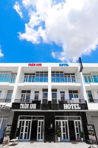 a large white hotel with arik amhm and a hotel at Hotel Trâm Anh in Nhơn Trạch