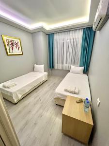 Postel nebo postele na pokoji v ubytování Mercan Otel