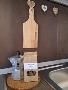 a kitchen counter with a box and a cutting board at B&By in viaggio in Putignano