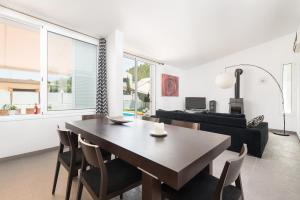 a living room with a wooden table and chairs at Domus Genti in Son Serra de Marina