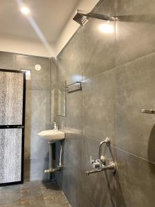 a bathroom with a sink and a shower at Kiara Studios Assagao by Goaround Homes in Assagao