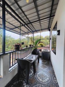 a balcony with a table and chairs and windows at Kiara Studios Assagao by Goaround Homes in Assagao