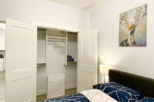 a bedroom with a bed and a closet at Two Bedroom Suite Burnaby Metrotown in Burnaby