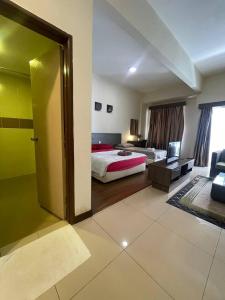 a hotel room with a bed and a sliding door at Junikastay BLagoon Melaka in Malacca