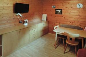 a dining room with a table and a tv on a wall at Apartment in Fusch an der Glocknerstra e in nature in Fusch an der Glocknerstraße