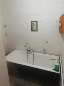 a bath tub in a bathroom with a picture on the wall at Chata Lužná u Hanušovic 