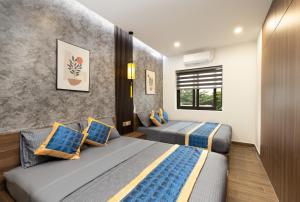 Postel nebo postele na pokoji v ubytování Hai Hội Villa Hoi An