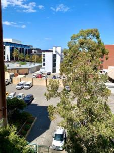 a parking lot with cars parked in a parking lot at Location Location Vacation in Fremantle