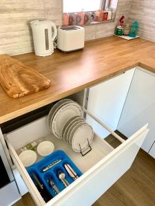 a kitchen drawer with utensils and appliances in it at Location Location Vacation in Fremantle