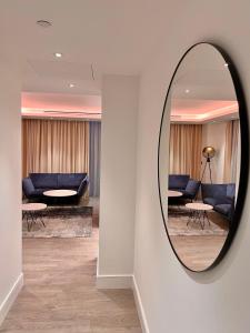 a mirror on a wall in a living room at 2Bedroom Apartment in Central of London in London
