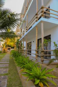 a house with a row of plants in front of it at Ahadi Homes in Mombasa