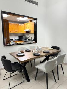 a dining room table and chairs in a kitchen at 2 Bedroom Entire Furnished- Future Museum & Trade Center in Dubai